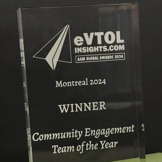 The glass AAM Global Awards 2024 trophy from eVTOL Insights, engraved Montreal 2024, Winner, Community Engagement Team of the Year